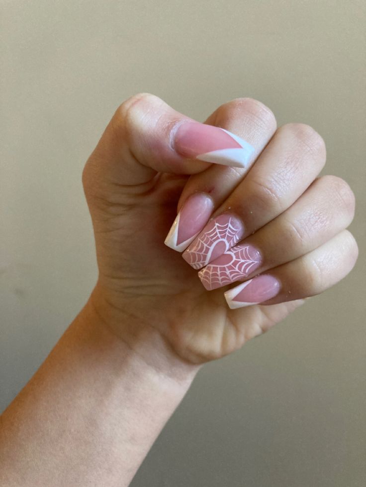 Elegant Soft Pink and French Tip Nail Design with Whimsical Spider Web Heart Accent.