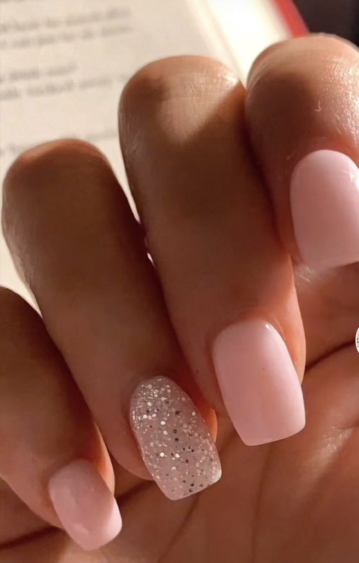 Elegant Soft Pink Nail Design with Sparkly Accent for a Touch of Glamour.