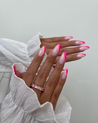 Trendy Vibrant Ombre Nail Design in Pink with Stylish Accessory.