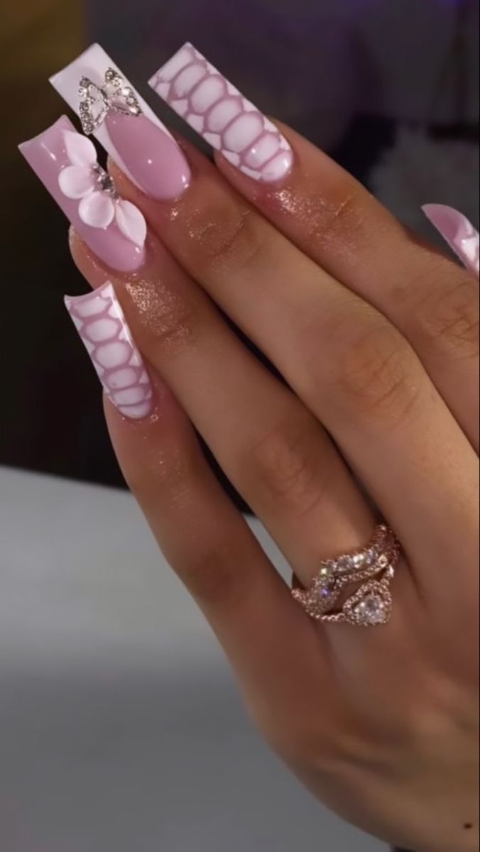 Elegant Long Nail Art with Soft Pink Shades, Floral Designs, and Gemstone Accents.