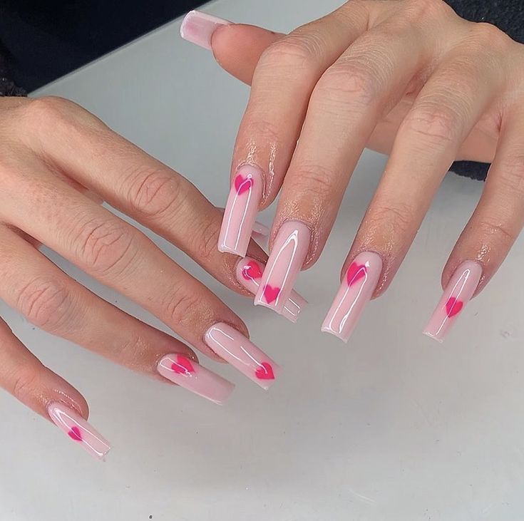 Charming Pink Nail Design with Heart Accents for a Romantic Touch.