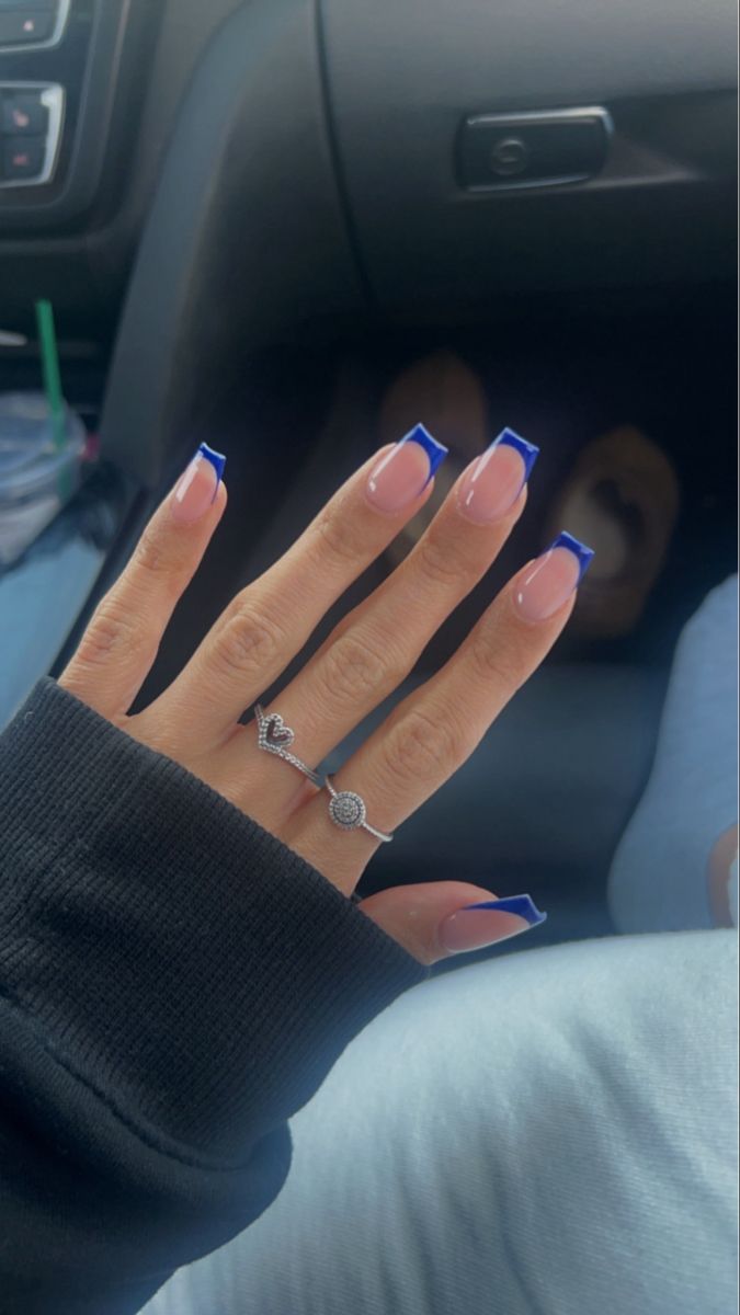 Chic Natural Pink Nails with Bold Blue Tips and Delicate Silver Accents.