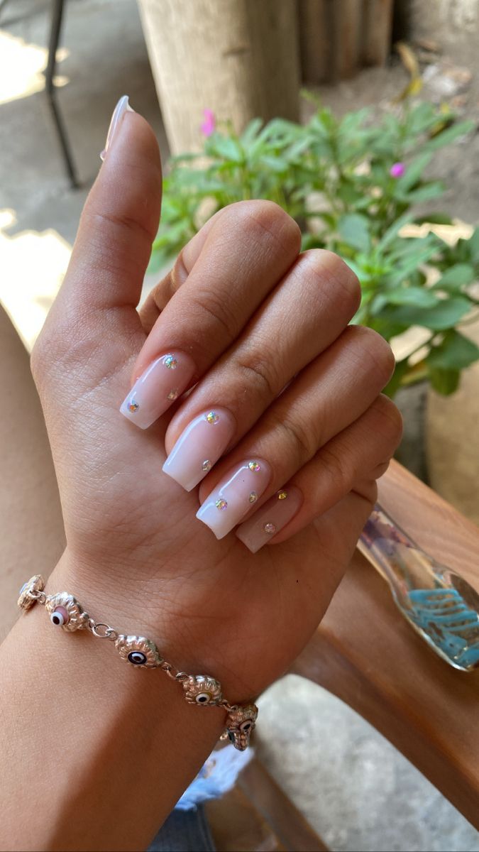 Sophisticated Soft Pink Square Acrylic Nails with Delicate Rhinestone Accents and Chic Bracelet.