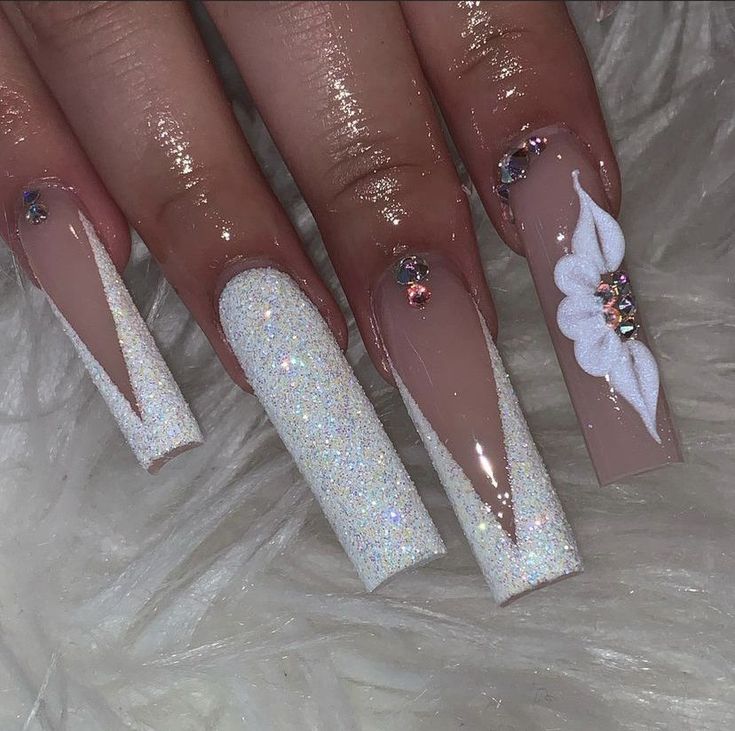 Elegant Nail Design with Glossy Nude, Sparkling White, and Floral Accents.