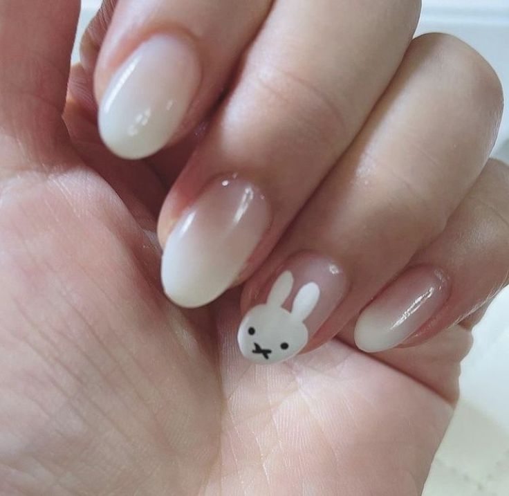 Whimsical Ombre Nail Design with Bunny Motif: A Perfect Blend of Elegance and Fun.