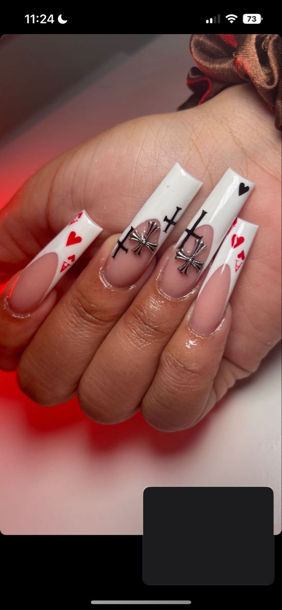 Dramatic Bold Nail Design with White and Red Patterns Featuring Heart Motifs and Cross Designs.