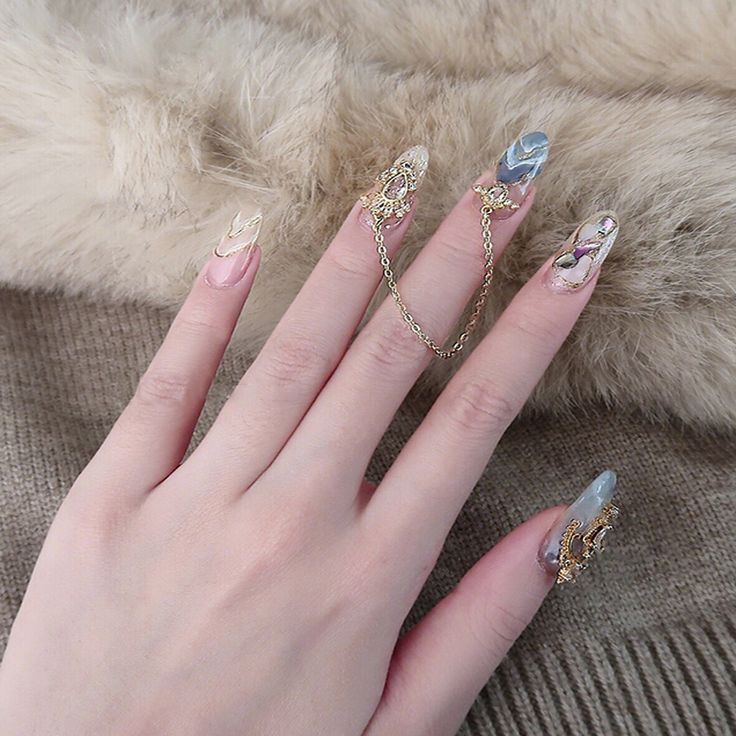 Sophisticated Elegant Nail Design with Elongated Tips and Embellished Pastel Hues.