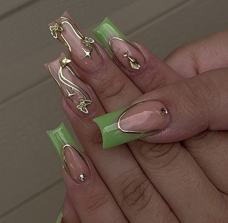 Chic Nail Design: Soft Green and Nude Palette with Elegant Gold Accents and Floral Motifs.