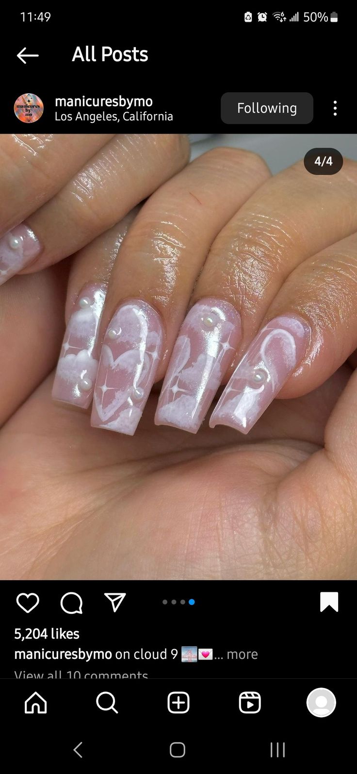 Charming Romantic Nail Design with Soft Pink Background and Intricate White Hearts.