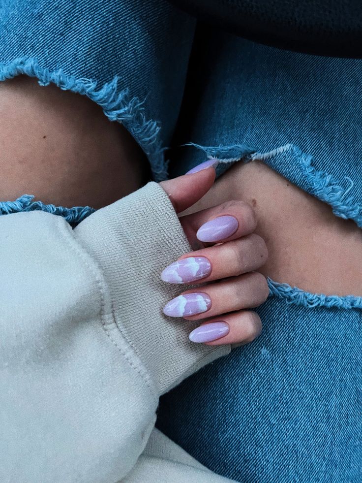 Whimsical Lavender and Pastel Pink Almond Nail Design with Cloud Patterns.