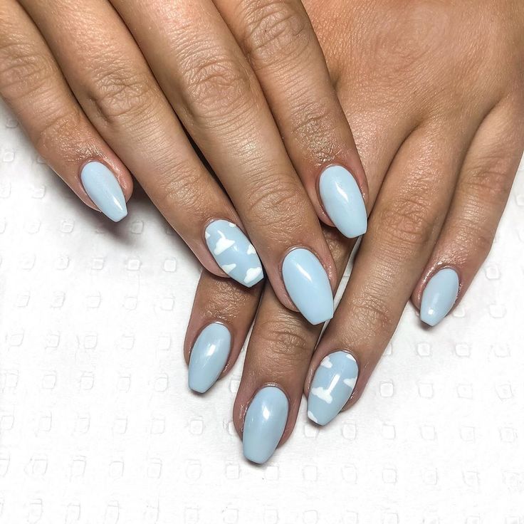 Elegant Soft Pastel Blue Almond-Shaped Nails with Glossy Finish and Playful Designs.