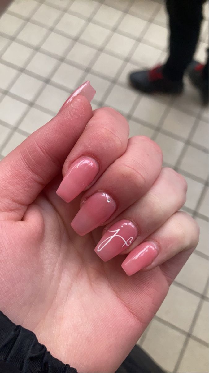 Elegant Glossy Pink Square Nails With Subtle Shine and Unique Accent.