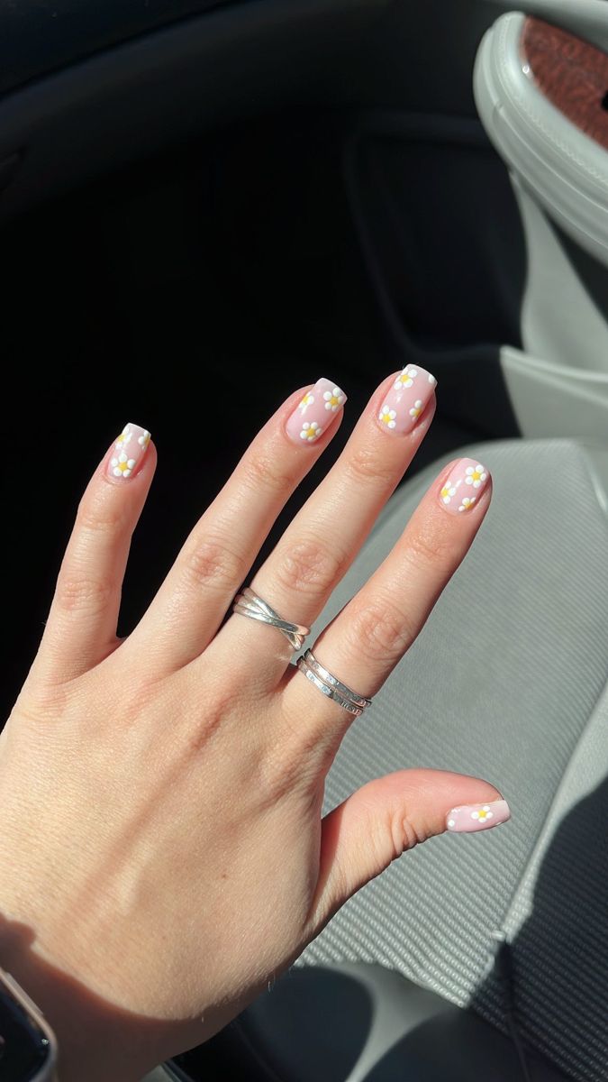 Charming Floral Nail Design with Soft Pink Base and Bright Accents.