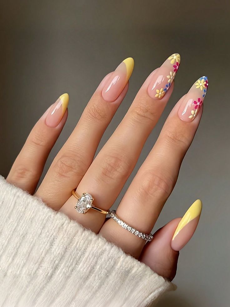 Charming Spring Nail Art: Almond-Shaped Design with Nude Base, Vibrant Yellow Tips, and Whimsical Floral Accents.