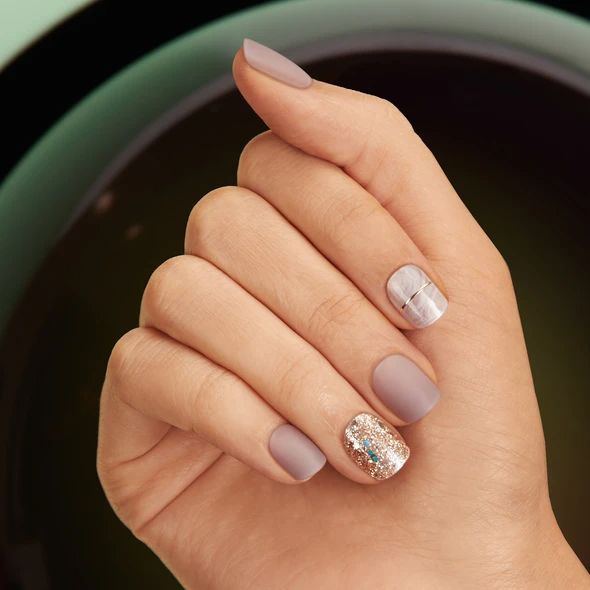 Sophisticated Nail Design: Taupe Base with Matte and Glossy Finish, Glitter Accent, and Subtle Embellishments.