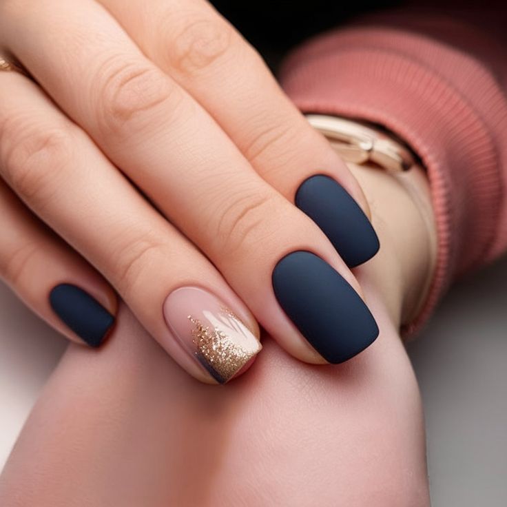 Elegant Navy Blue and Nude Nail Design with Gold Glitter Accent for All Occasions.