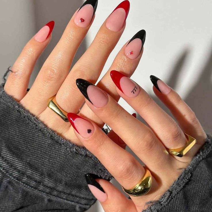 Chic Almond-Shaped Nails: Bold Red and Black Tips with Playful Heart Accents.