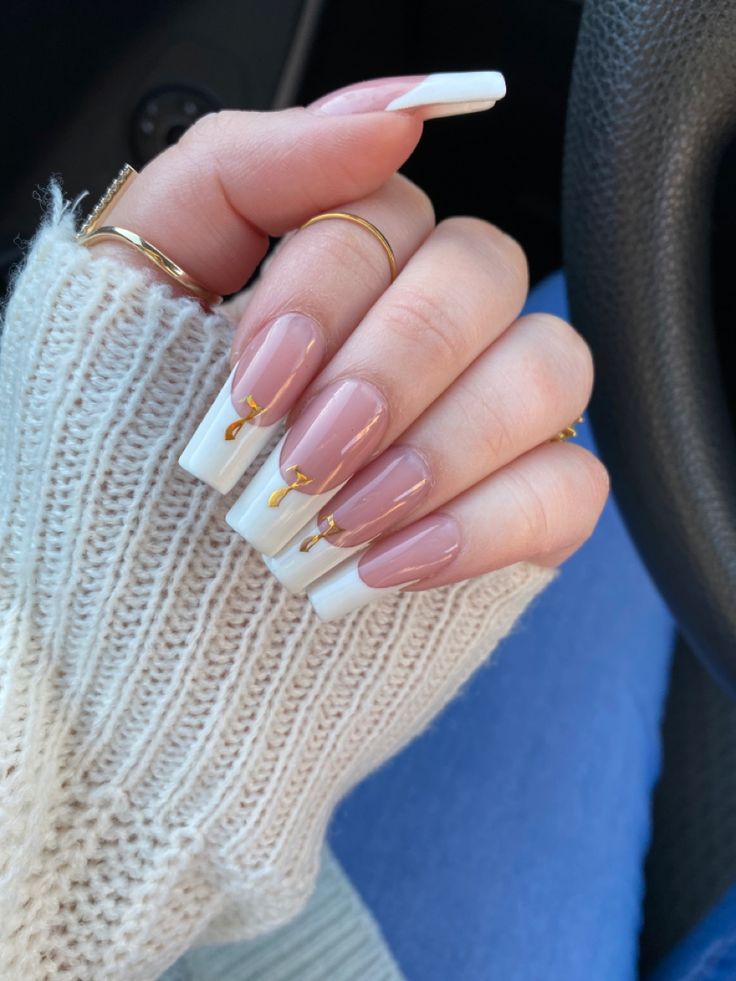 Chic Nude Nail Design with White Tips and Gold Accents for a Sophisticated Look