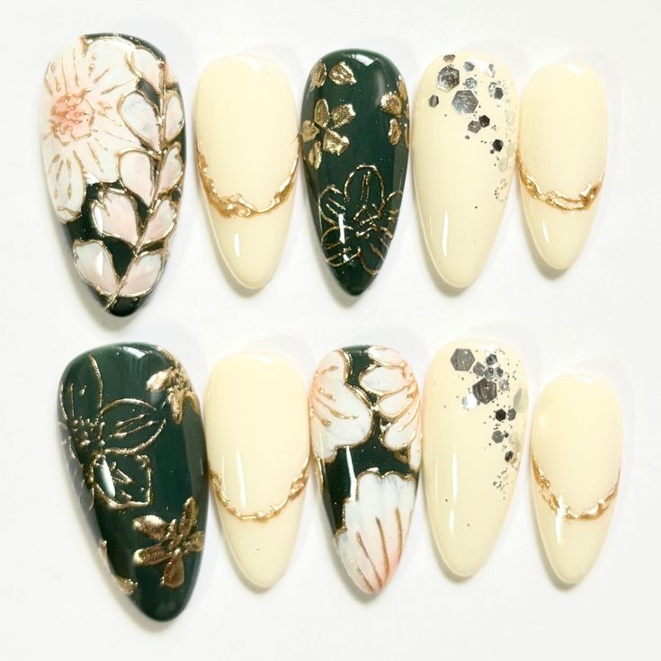 Chic nail design with glossy and matte finishes, soft yellow and deep green hues, and intricate floral patterns in gold and pink.