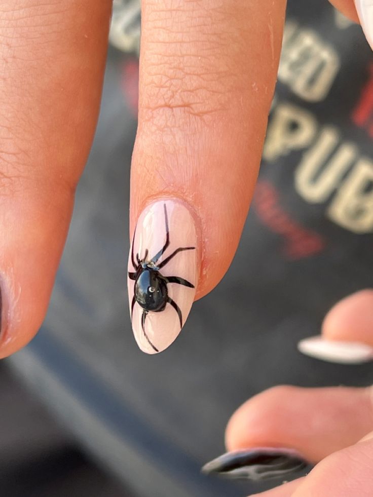 Spooky Black Spider Nail Art: A Creamy Canvas for Halloween Elegance.