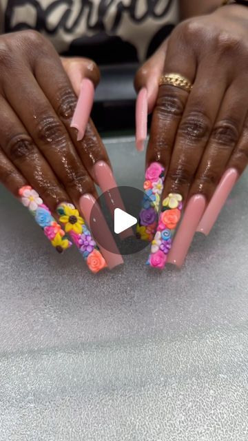 Vibrant Long Square Nail Design with Glossy Pink and Colorful 3D Floral Embellishments.