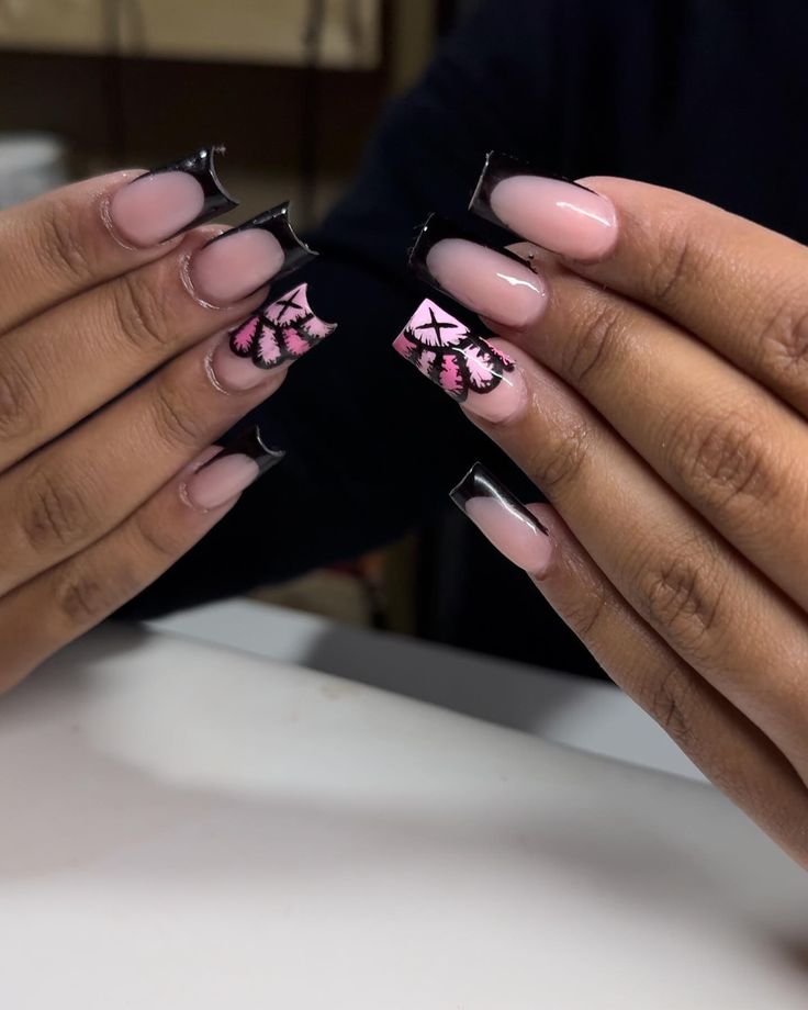 Sophisticated Floral Nail Design in Soft Pink and Glossy Black Tips.