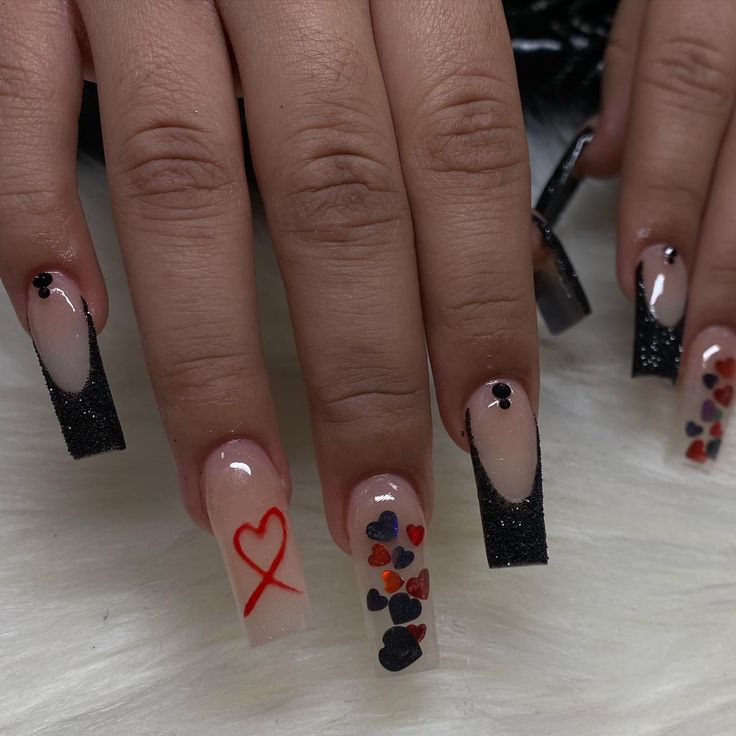 Whimsical Nail Design: Nude Base with Black Glitter Tips and Playful Heart Motifs