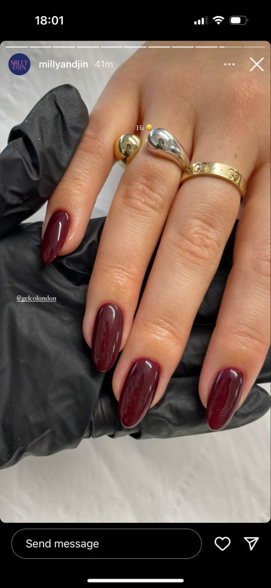 Sophisticated Deep Burgundy Almond Nails with Glossy Finish and Sparkling Rings.