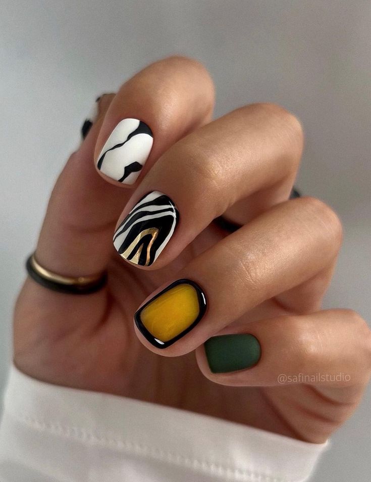 Chic Geometric and Abstract Nail Design with Bold Yellow Accent and Earthy Tones