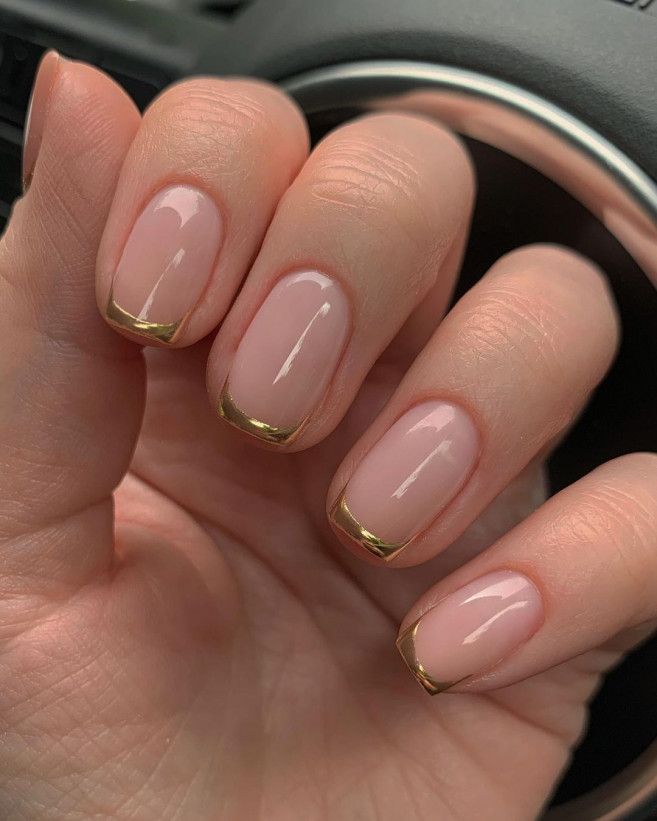 Sophisticated Nude Base with Sleek Gold Tips: A Modern Twist on Classic French Manicure.