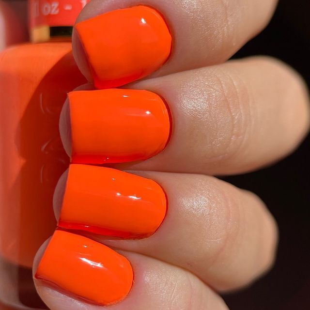 Bold Vibrant Orange Nail Design: A Glossy Statement for Summer and Festive Celebrations.