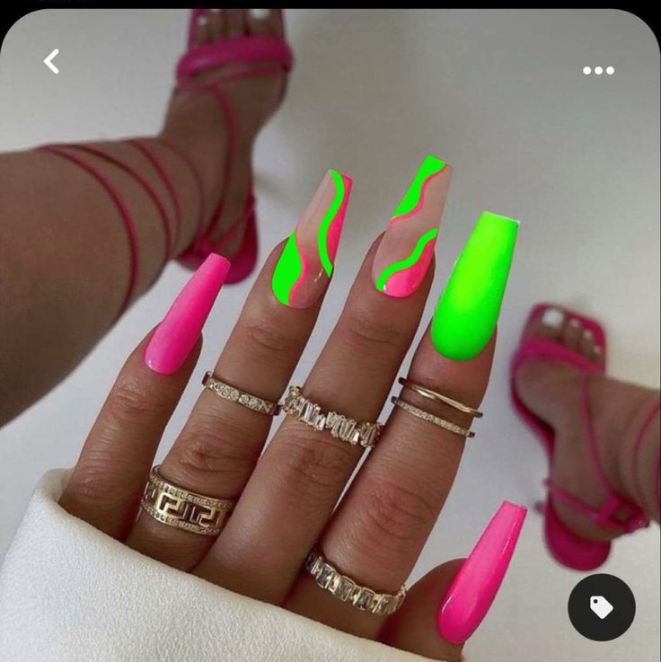 Bold Neon Pink and Green Nail Design with Abstract Patterns and Stylish Accessories.