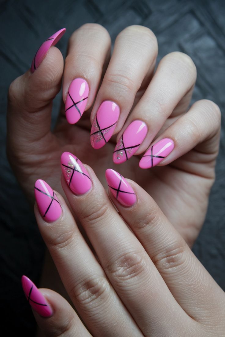 Chic Bright Pink Nails with Glossy Finish and Geometric Black Lines Enhanced by Glitter.