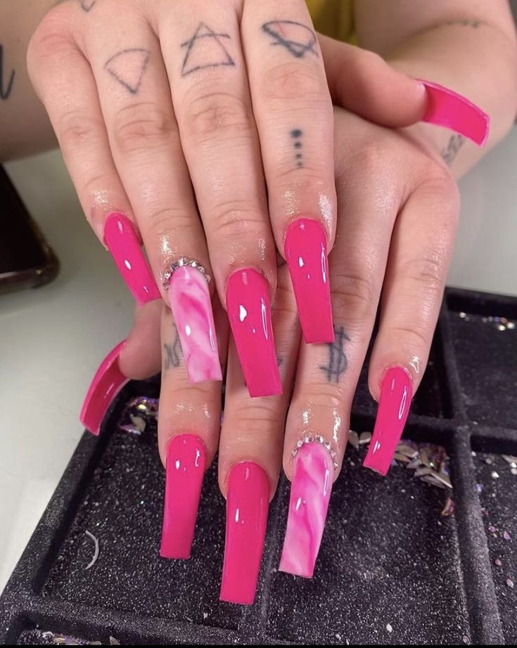 Bold Glam: Striking Pink Marble Nail Art with Glossy Finishes and Modern Designs