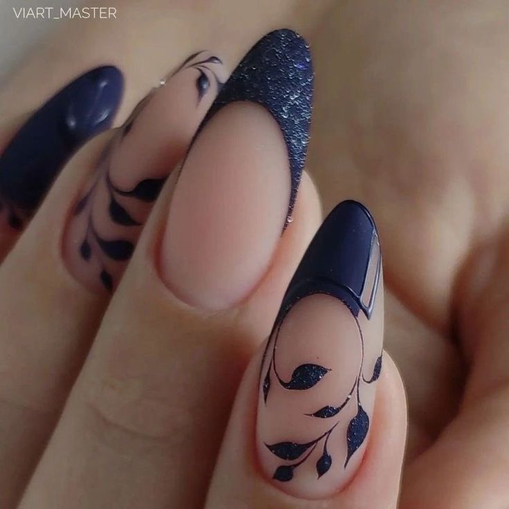 Sophisticated Nail Design: Deep Navy with Floral Patterns and Glamorous Finishes.