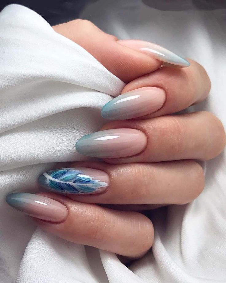 Elegant Ombre Nail Design: Soft Pink to Serene Blue Gradient with Feather Art and Glossy Finish.