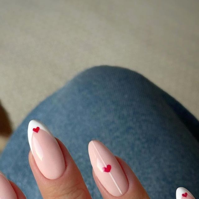 Chic Almond-Shaped Nails: Elegant Pink Base with French Tips and Playful Red Hearts