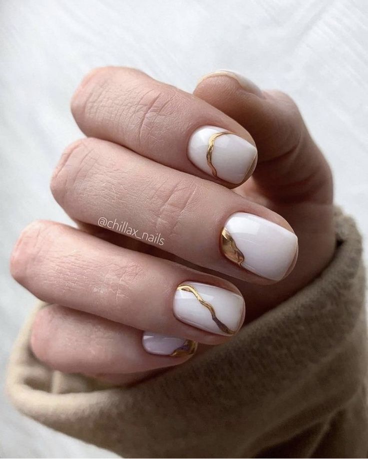 Chic White Nail Design with Delicate Gold Accents for Sophisticated Elegance.