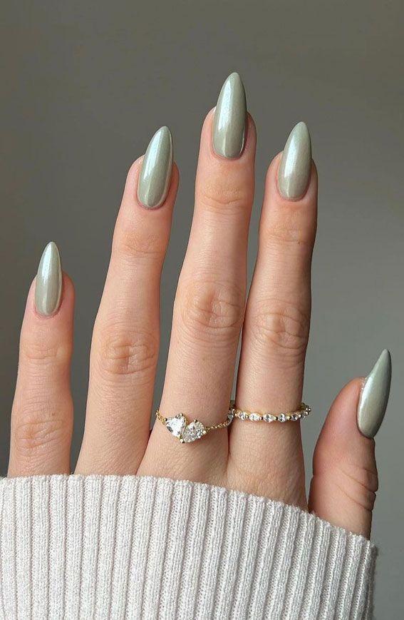 Sophisticated Almond-Shaped Nails in Soft Green Polish with Delicate Sparkling Rings