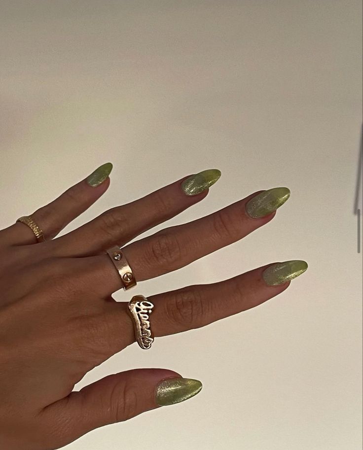 Elegant Almond-Shaped Glossy Green Nails Paired with Delicate Gold Rings