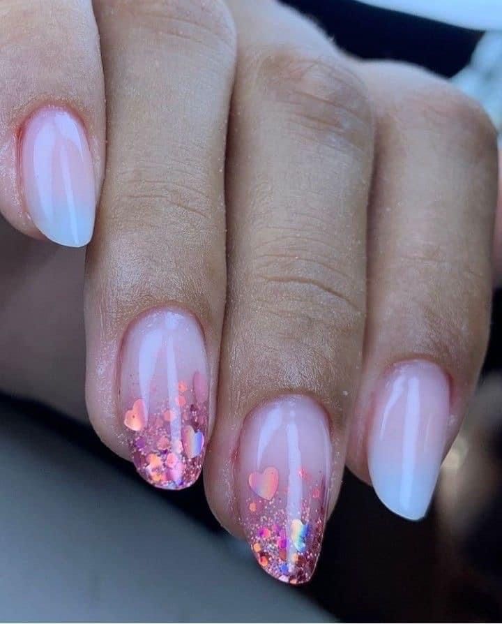 Playful Ombre Glitter Nail Design with Heart-Shaped Confetti