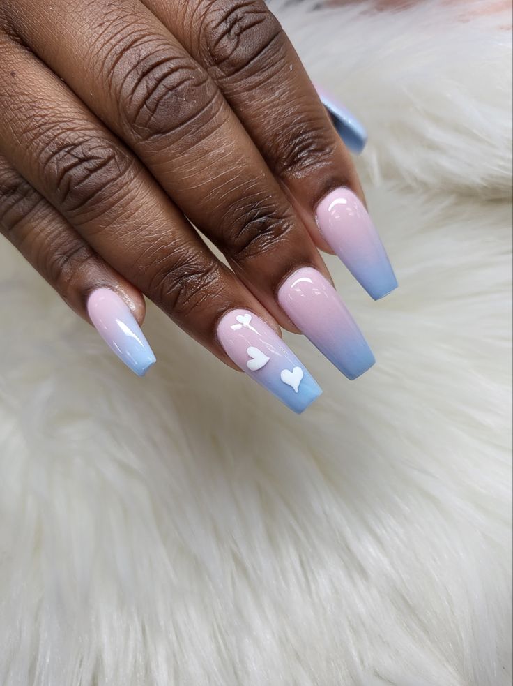 Chic Ombre Nail Design: Soft Pink and Light Blue Gradient with Heart Accents.