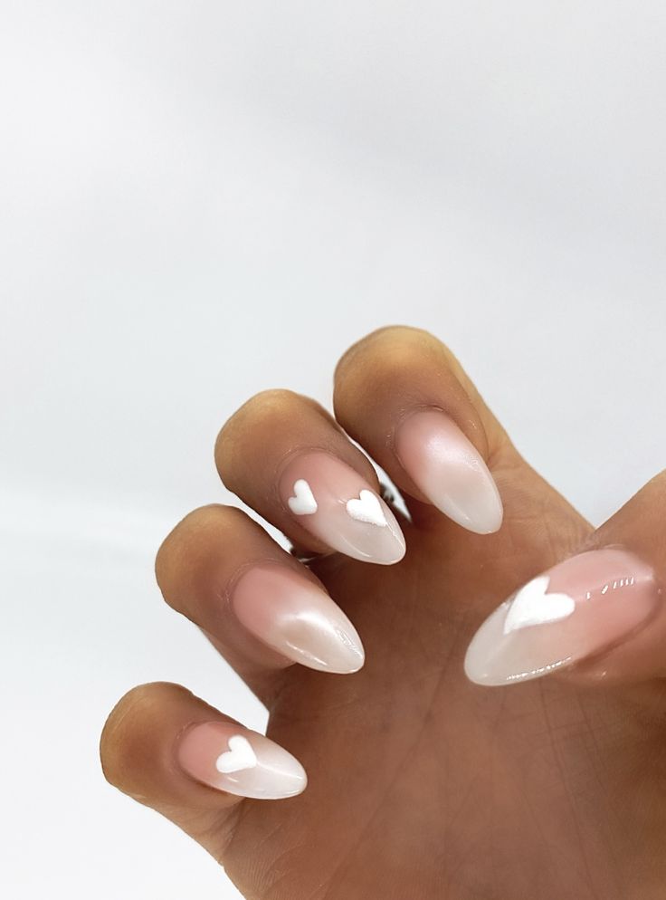 Charming Heart Ombre Nail Design: Nude to White with Delicate Hearts.