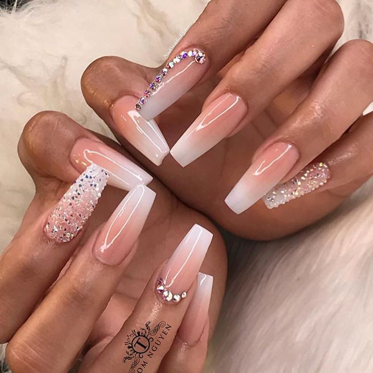 Elegant Pink and White Ombre Nail Art with Glitter and Rhinestones.