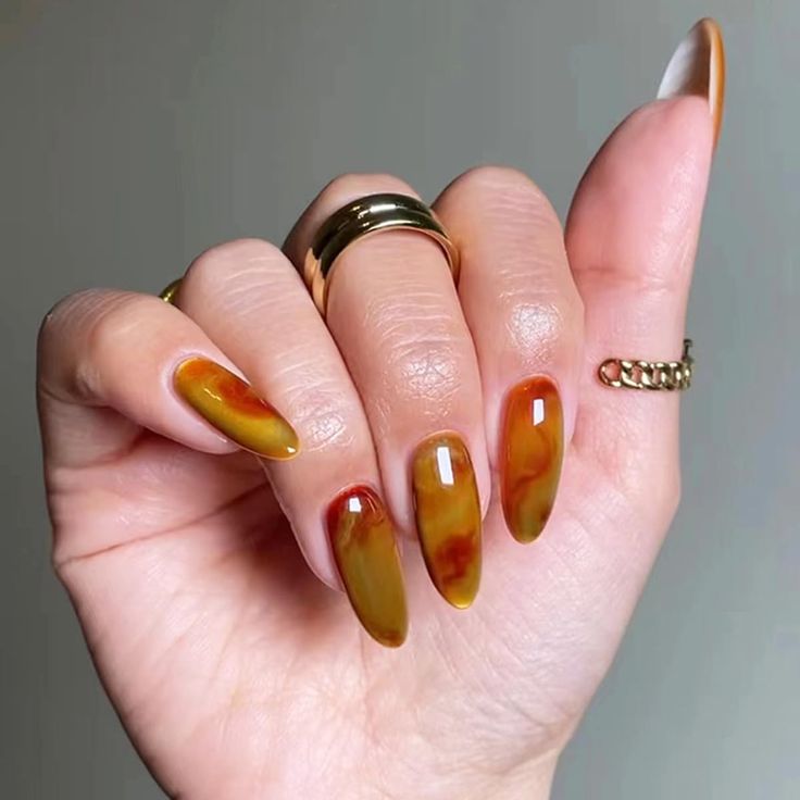 Chic Ombre Nail Design in Warm Earthy Tones with Stylish Accents.