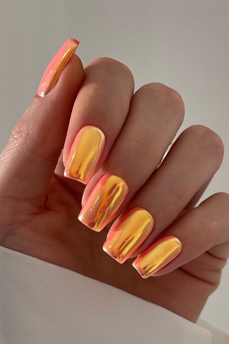 Vibrant Pink and Orange Ombre Nail Design for a Bold, Shimmering Statement.