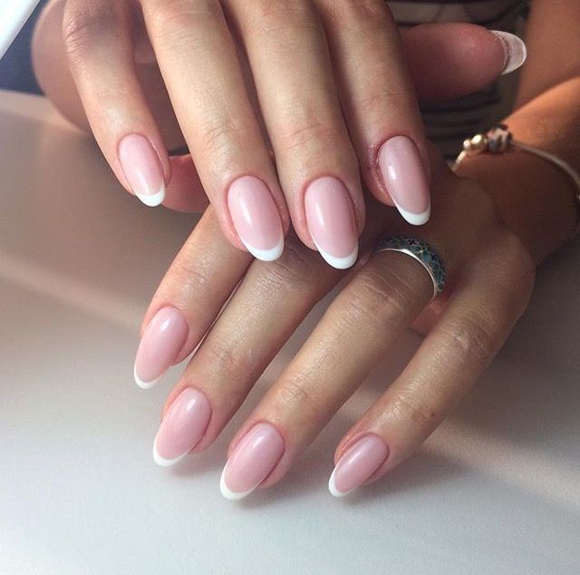 Sophisticated French Manicure: Elegant Almond-Shaped Nails with Soft Pink Base and Classic White Tips.