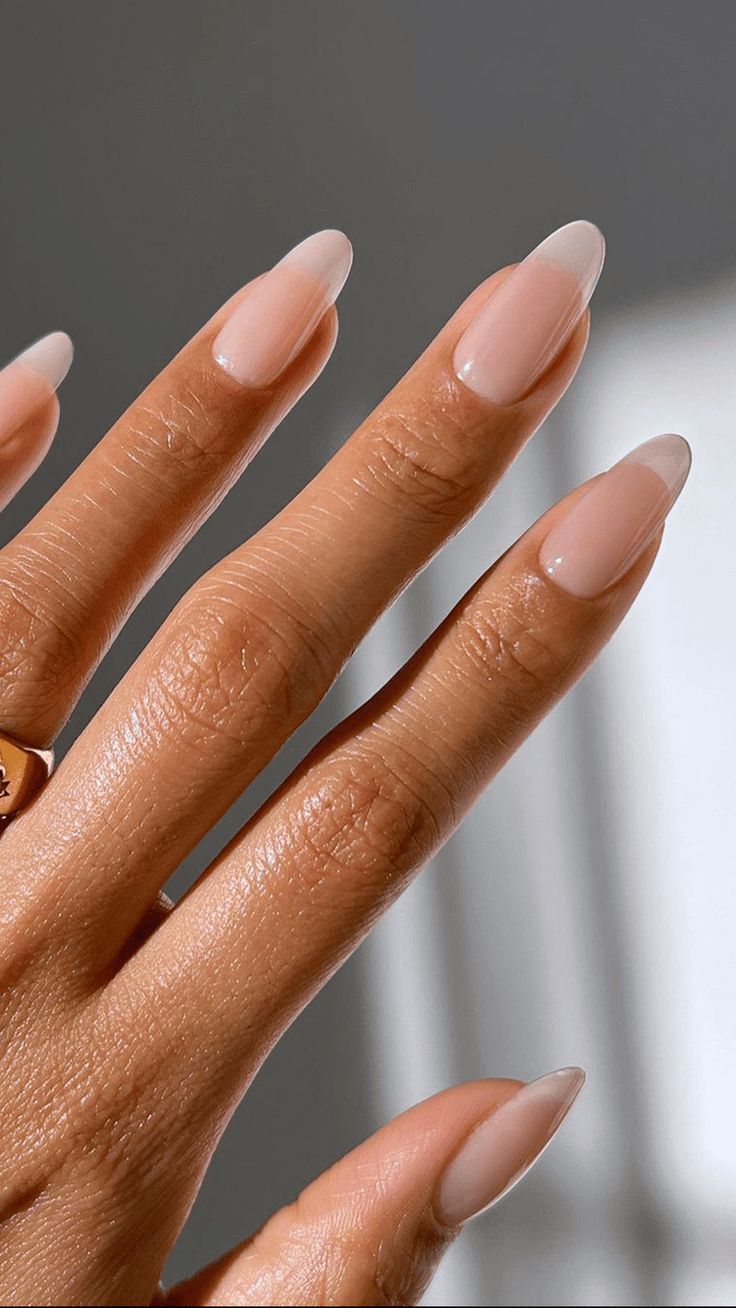 Chic Almond-Shaped Nude Nails with Subtle French Tips: A Sophisticated Look for Every Occasion.