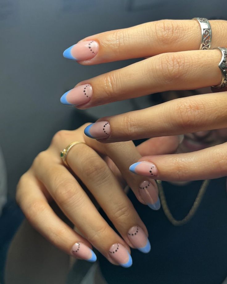 Elegant Almond-Shaped Nail Design with Soft Pink and Vibrant Blue Accents and Dotted Patterns.