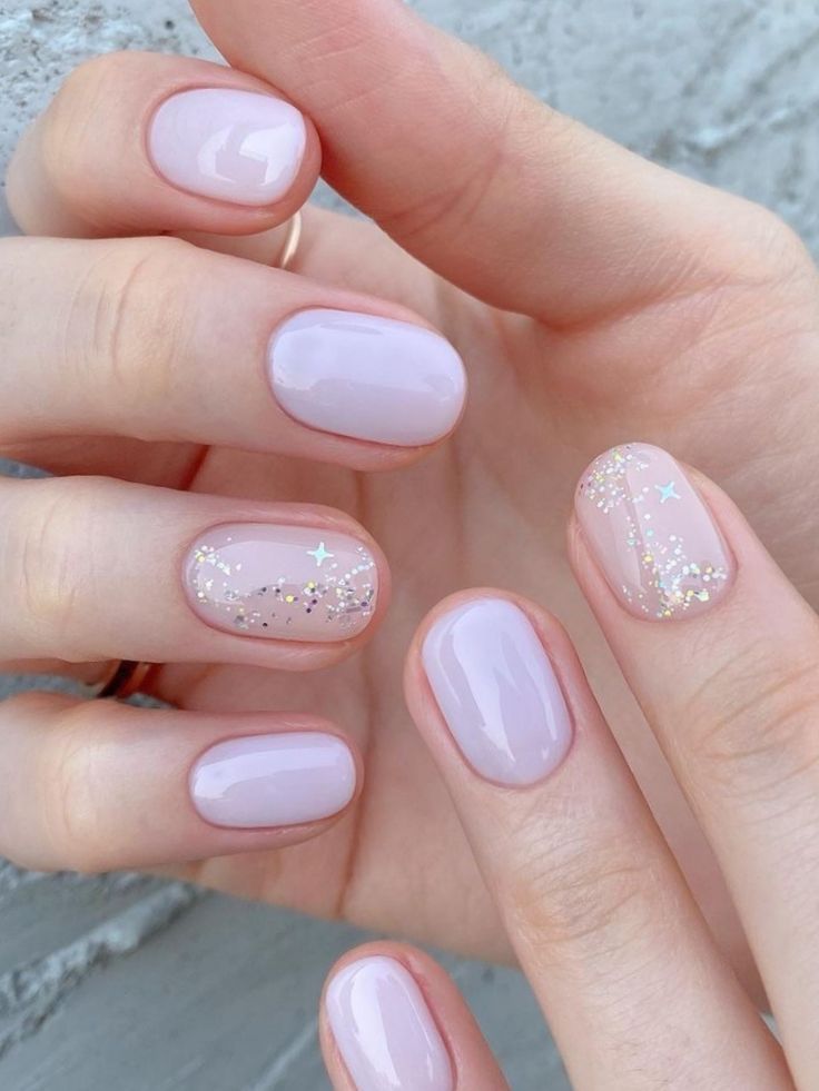 Elegant Pastel Lavender Nail Design with Glitter and Star Accents.